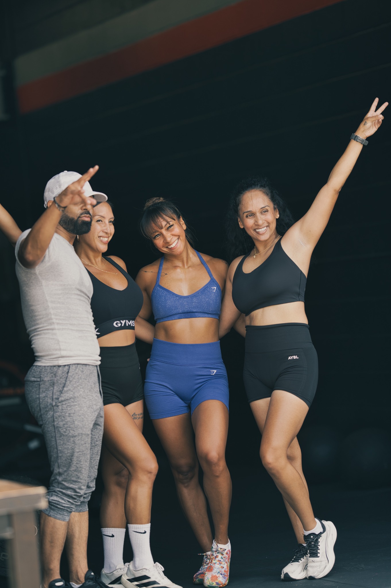 Four Rhino Fitness community members smiling together in the gym